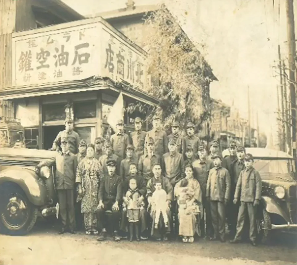 商店の前で集合写真を撮る集団